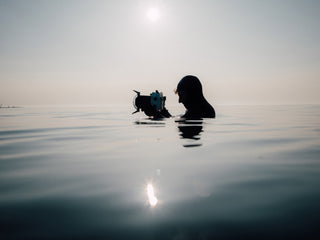 A water photographer taking pictures of surfers in the North Sea.