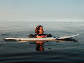A surfer waiting for a wave of the coast of Germany in the North Sea.