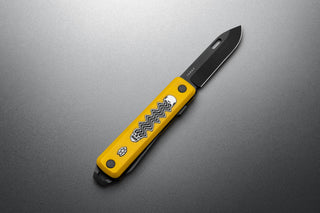 The Bryce Wong artist series Ellis EDC multitool pocket knife on a steel surface.