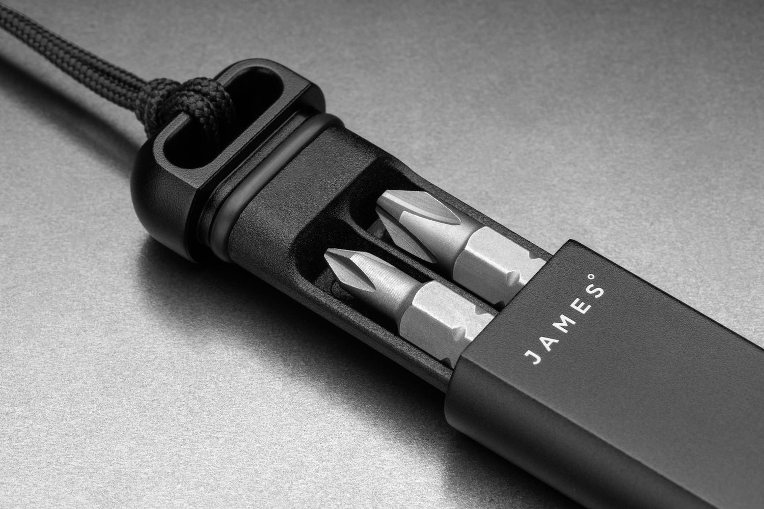 The Warrick EDC screwdriver bit driver in black open exposing the storage area.