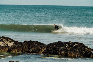 A woman surfing a point break in Baja California.