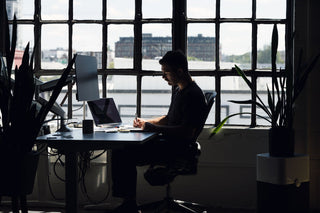 A man sketching at his desk.