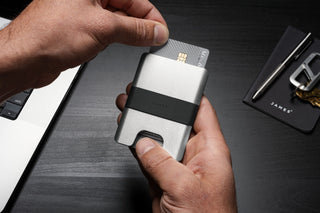 A man removing a credit card from the Lowe wallet.