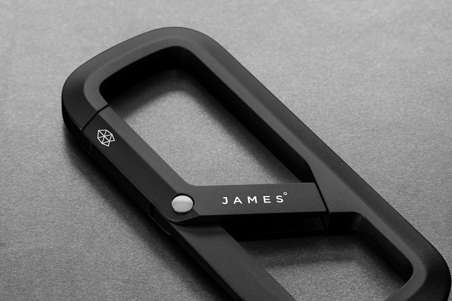 The Madison keychain carabiner on a steel surface.