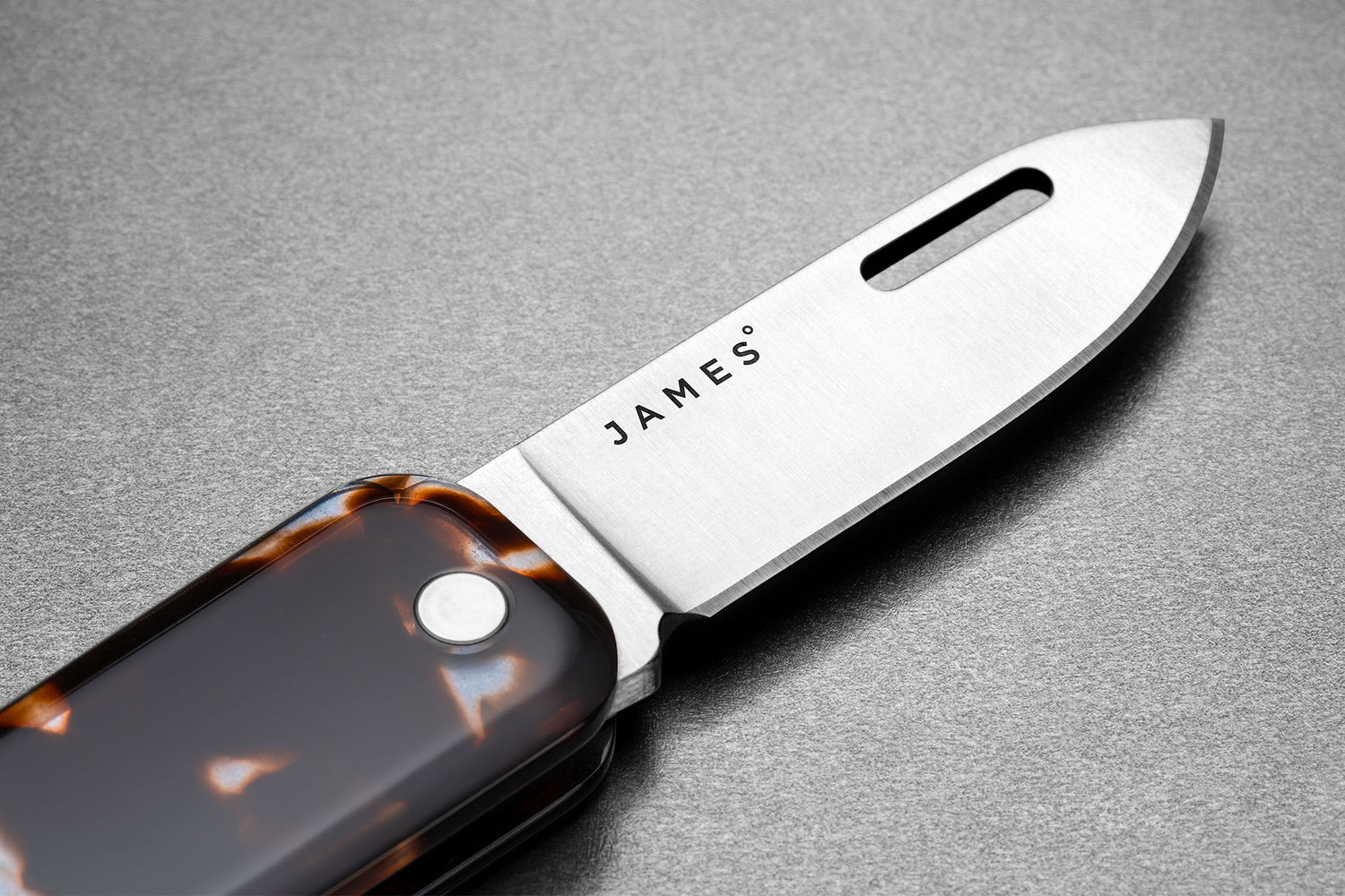 The blade of The Elko EDC keychain folding pocket knife with eco acetate scales.