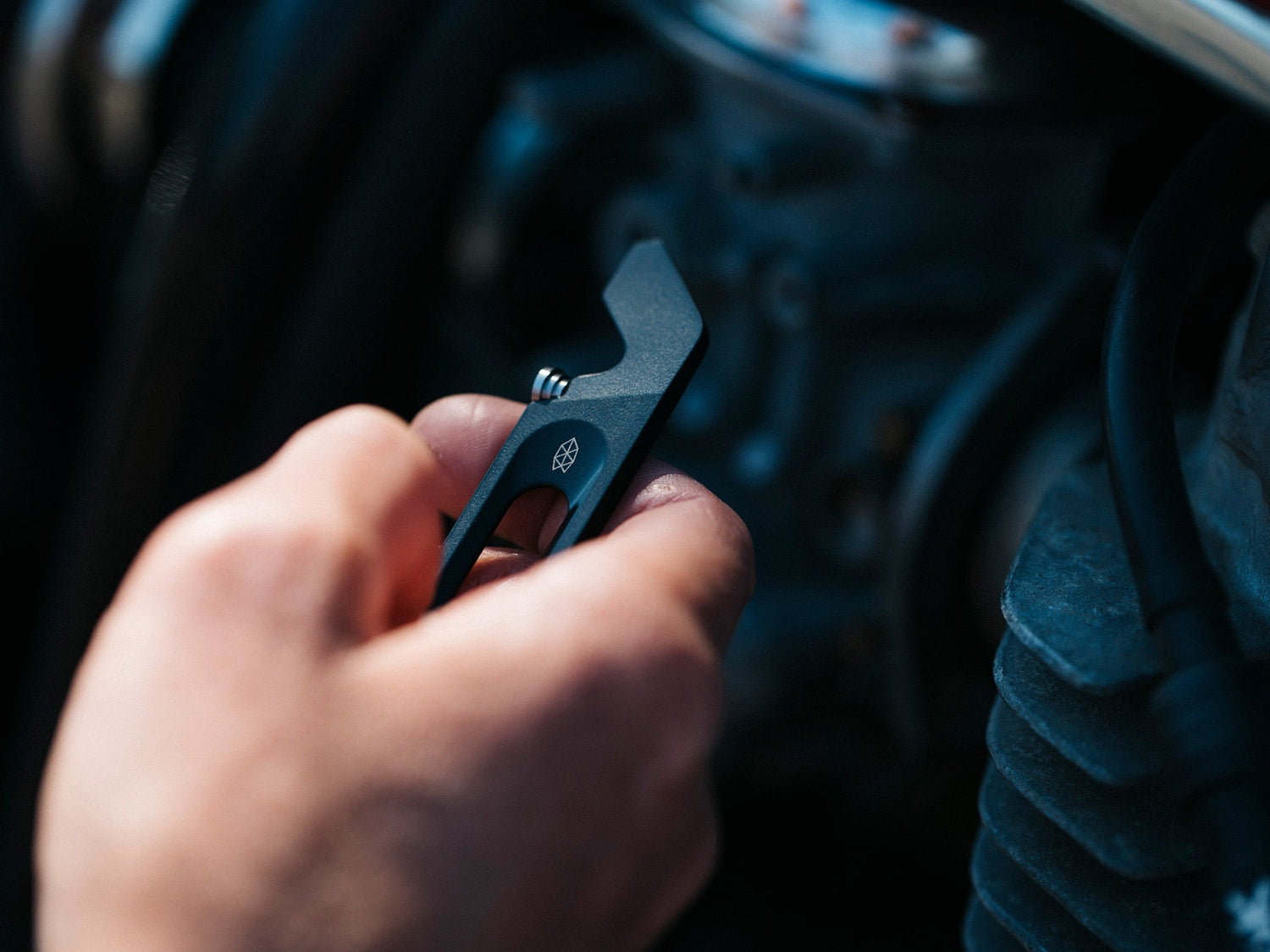 The Halifax EDC keychain multitool in a man's hand.