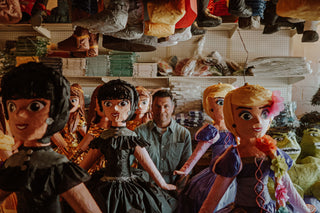 Josh Rosen sitting amongst pinatas.