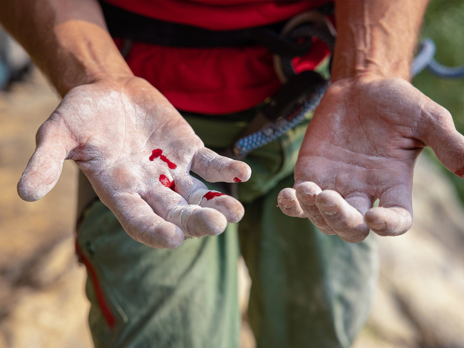 Professional rock climber and photographer Savannah Cummins chalked up hands.