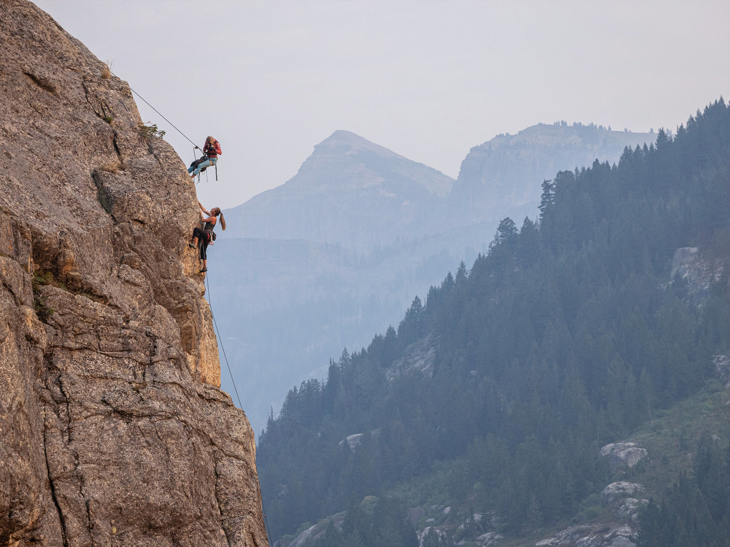 Professional rock climber and photographer Savannah Cummins photographing an ascent.