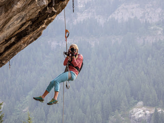 Professional rock climber and photographer Savannah Cummins taking a photo of another photographer.