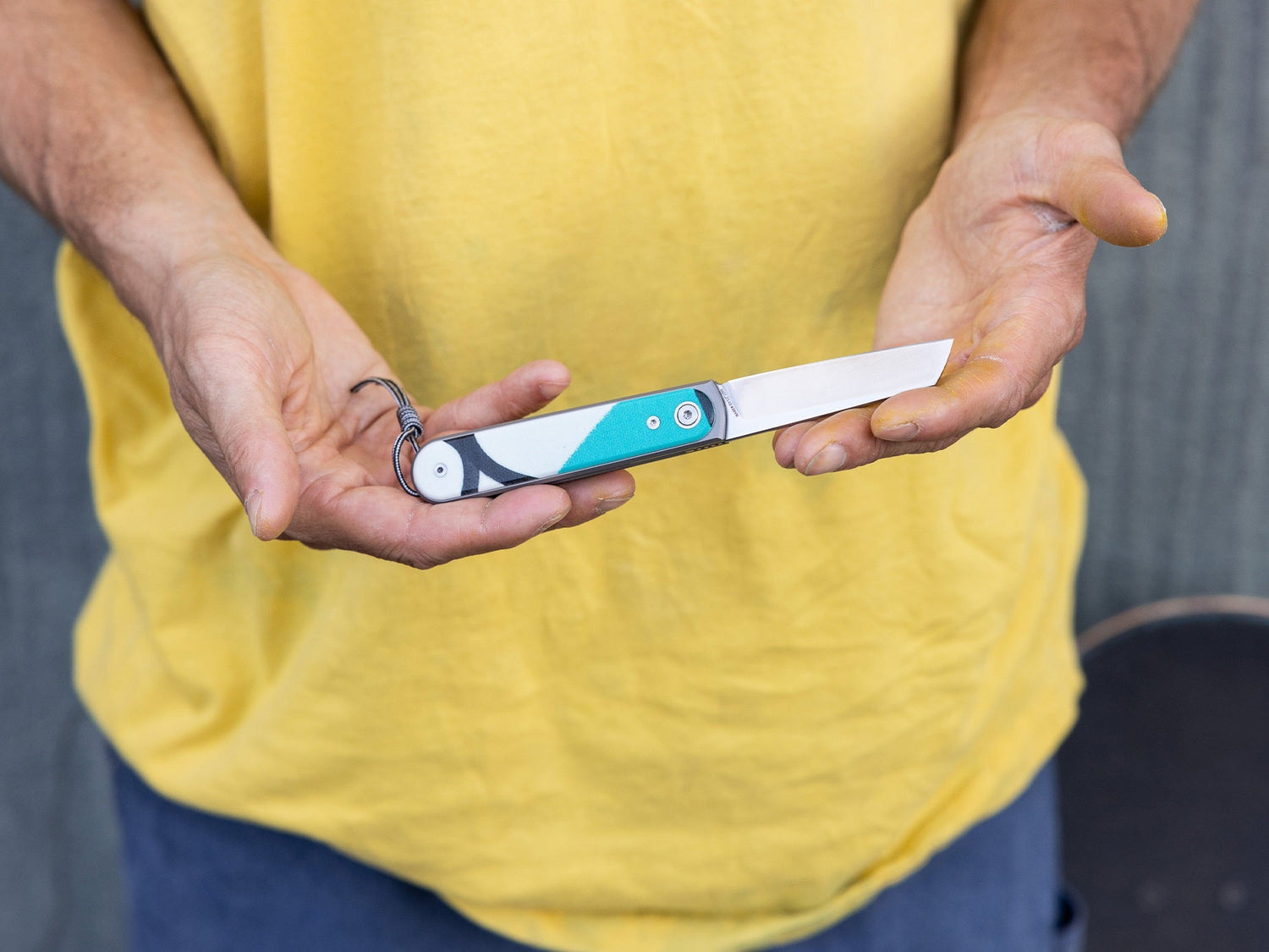 Artist Sebo Walker holding his collaboration knife.