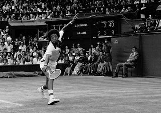 Tennis player Arthur Ashe hitting backhand.