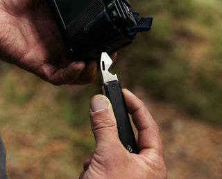 The Ellis EDC multitool pocket knife being used to adjust a camera. 