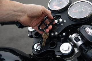 A man with his motorcycle keys on the Hardin EDC keychain carabiner.