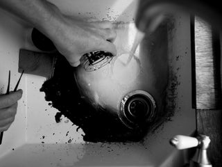 UK artist Schoph Schofield dumping paint down the sink.