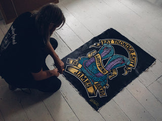 UK artist Schoph Schofield looking over the James Brand collaboration poster artwork.