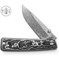 The Barnes integral titanium pocket knife with snow carbon scales and a Damasteel blade.