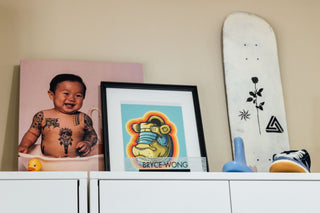 Photos and artwork in artist Bryce Wong's art studio.