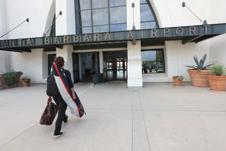 Professional surfer Connor Coffin walking into the Santa Barbara airport with his surfboard bag.