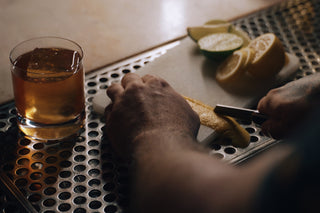A bartender preparing a garnish with his Pike classic folding slip joint pocket knife.