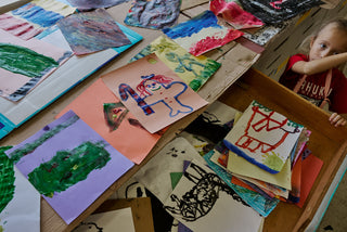 An art student overlooking all of the classes work.