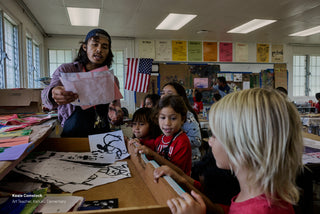 The art teacher of Kahuku elementary school working with students.