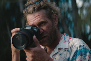 Skateboarder and photographer Arto Saari taking a photo.