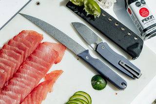 The Humboldt Fillet knife and Folsom Pro pocket knife on a cooler next to fresh sashimi. 