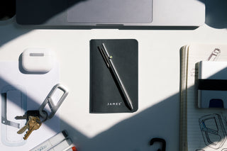 The Kent bolt-action pen on a notebook on a desk.