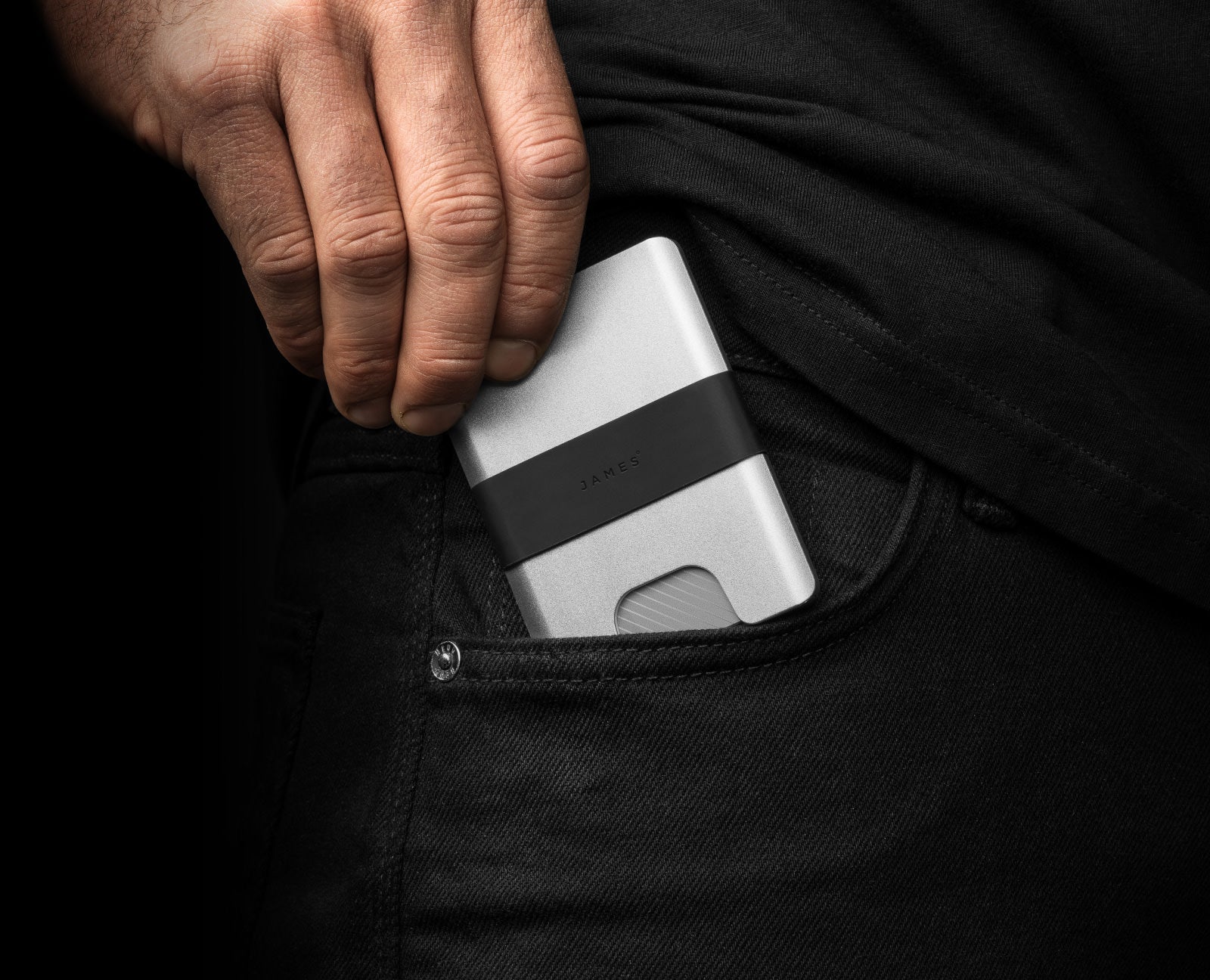 The Lowe minimalist card holder wallet in silver and black in pocket.