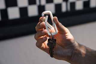 The Madison carabiner being opened.