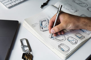 A person writing in a sketch book.