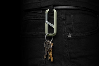 The Madison keychain carabiner hanging from a belt loop.