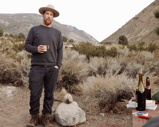 Embry Rucker standing in the wilderness.