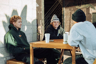 Three men getting coffee. 