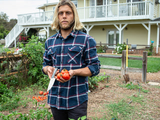 Professional surfer Connor Coffin using his fixed blade Hells Canyon knife to harvest tomatoes.