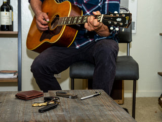 Professional surfer Connor Coffin playing guitar at home.
