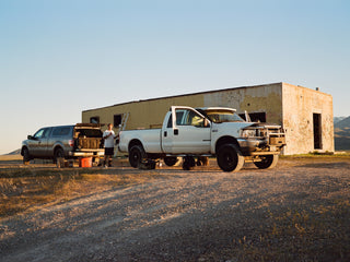 Artist Jess Mudgett preparing to paint a mural while getting supplies from his truck.
