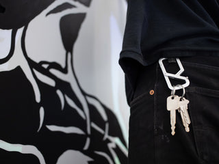 Artist Jess Mudgett wearing his Mehlville keychain carabiner on his belt loop.