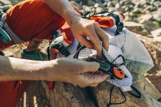 Savannah Cummins pulling her Redstone folding pocket knife from her pack.