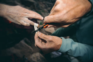 Savannah Cummins using her Redstone pocket knife to trim the tape on her finger.