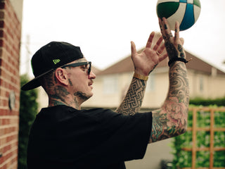 Professional barber Paul Hewitt shooting a basketball.