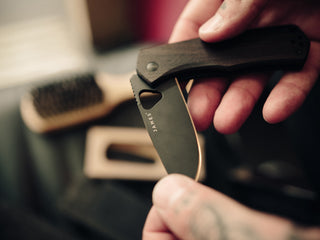 Professional barber Paul Hewitt with his Folsom EDC liner lock folding pocket knife in hand.