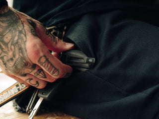 Professional barber Paul Hewitt with his Folsom EDC folding liner lock pocket knife clipped to his pocket.