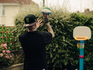 Professional barber Paul Hewitt shooting a jump shot on his sons basketball hoop.