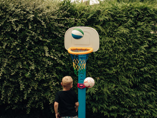 Professional barber Paul Hewitt's son shooting a basketball in the backyard.