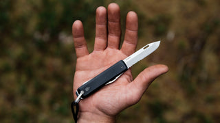 A EDC multitool pocket knife in hand.