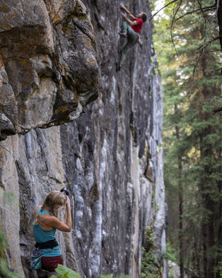 Professional rock climber and photographer Savannah Cummins taking photos.