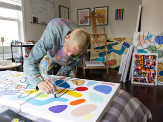 Artist Sebo Walker working on a painting.