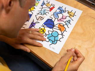 Artist and skateboarder Sebo Walker signing art prints.